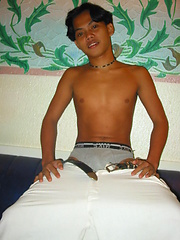 Cute thai twink lies on the coach
